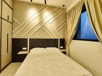 a bedroom with a large bed with a window at The Luxe stay Bukit Bintang in Kuala Lumpur