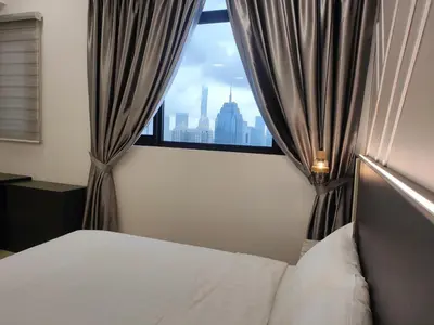 a bedroom with a window with a view of a city at The Luxe stay Bukit Bintang in Kuala Lumpur