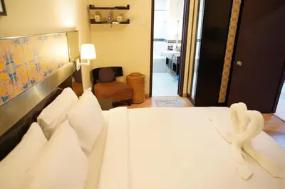a bedroom with a white bed with towels on it at The Luxe stay Bukit Bintang in Kuala Lumpur