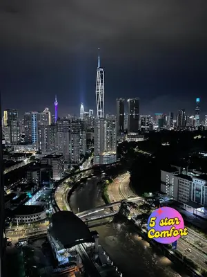 a view of a city skyline at night at 5 Star Comfort Riveria City KL Sentral 2pax Infinity pool in Kuala Lumpur