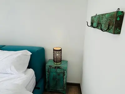 a bedroom with a bed and a table with a lamp at 3 bedroom apt L21 in kl sentral with city view in Kuala Lumpur