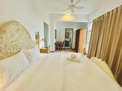 a bedroom with a large white bed with a hat on it at 3 bedroom apt L21 in kl sentral with city view in Kuala Lumpur