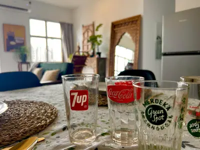 a table with two empty glasses on top of it at 3 bedroom apt L26 at kl sentral with city view in Kuala Lumpur