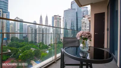 a balcony with a table with a vase of flowers at Harmony Luxury Suites At TM Persiaran Stonor KLCC in Kuala Lumpur