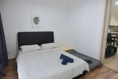 a bedroom with a large bed with a black headboard at Modern 2BR Fairlane Retreat Steps from Lot 10 in Kuala Lumpur