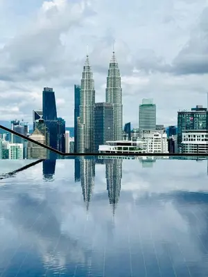 a city skyline with its reflection in the water at The Luxe by Infinitum KLCC by CASABELLESTAY in Kuala Lumpur