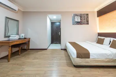 a hotel room with a bed and a desk at Hotel grand orchard in Kuala Lumpur