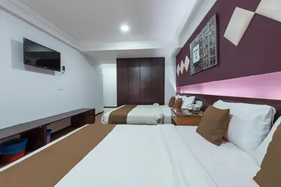 a hotel room with two beds and a tv at Hotel grand orchard in Kuala Lumpur
