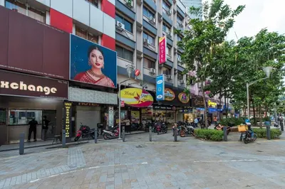 a street in a city with many shops at Hotel grand orchard in Kuala Lumpur