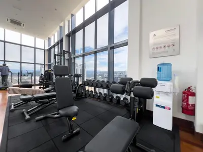 a gym with cardio equipment in a building with windows at Novo Ampang KL near Gleneagles by Sleepy Bear in Kuala Lumpur