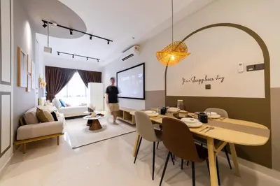 a man standing in a living room with a dining room at Novo Ampang KL near Gleneagles by Sleepy Bear in Kuala Lumpur