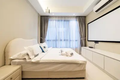 a bedroom with a bed and a projection screen at Novo Ampang KL near Gleneagles by Sleepy Bear in Kuala Lumpur