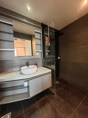 a bathroom with a sink and a mirror and a shower at EXPRESSIONZ DESIGNER SUITES Host By AURORA PREMIUM STAY in Kuala Lumpur