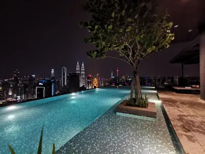 a swimming pool with a tree on top of a building at EXPRESSIONZ DESIGNER SUITES Host By AURORA PREMIUM STAY in Kuala Lumpur