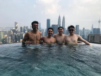 a group of men in a swimming pool on a skyscraper at EXPRESSIONZ DESIGNER SUITES Host By AURORA PREMIUM STAY in Kuala Lumpur