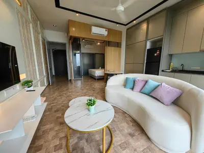 a living room with a couch and a table at EXPRESSIONZ DESIGNER SUITES Host By AURORA PREMIUM STAY in Kuala Lumpur