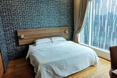 a bedroom with a bed and a large window at KL Tower View 3room 2bath 1free parking KLCC in Kuala Lumpur