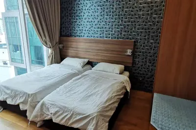 two beds sitting next to each other in a bedroom at KL Tower View 3room 2bath 1free parking KLCC in Kuala Lumpur