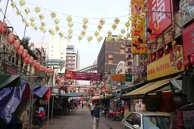 a city street with a bunch of signs and buildings at KL Tower View 3room 2bath 1free parking KLCC in Kuala Lumpur