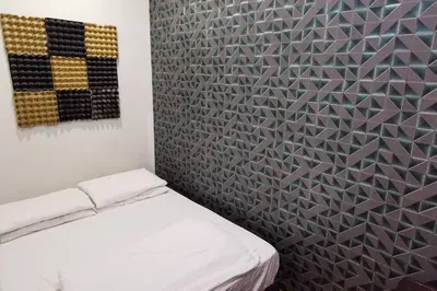 a room with a bed and a wall with a pattern at KL Tower View 3room 2bath 1free parking KLCC in Kuala Lumpur
