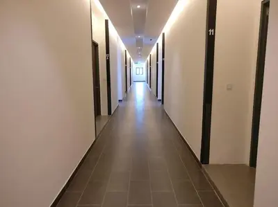 a long hallway with white walls and a tile floor at 3min Bangsar LRT-1 Station to KL Sentral-SuperView in Kuala Lumpur