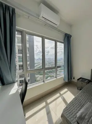a bedroom with a large window with a view of a city at Rc Residences in Kuala Lumpur