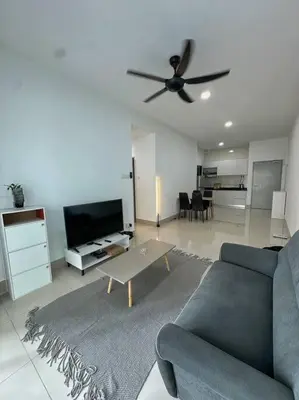 a living room with a couch and a ceiling fan at Rc Residences in Kuala Lumpur