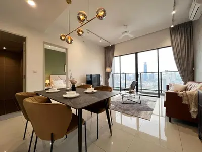 a dining room and living room with a table and chairs at Trion klcc view apartment near TRX in Kuala Lumpur