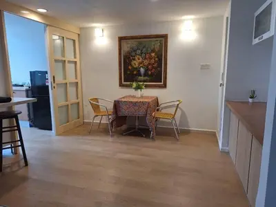 a dining room table with chairs and a painting on the wall at Fahrenheit, Stay in the Heart of KL, 15 pax in Kuala Lumpur