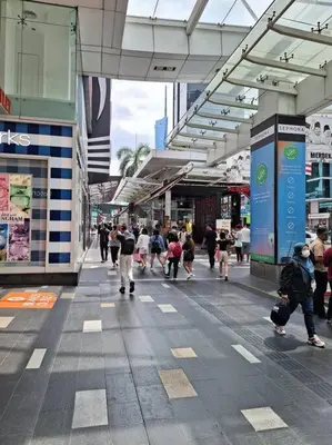 a group of people walking down a street in a city at Fahrenheit, Stay in the Heart of KL, 15 pax in Kuala Lumpur