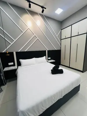a bedroom with a white bed with a hat on it at The Luxe Stay Chamber KL in Kuala Lumpur