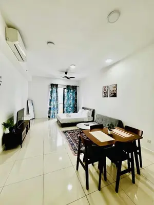 a living room with a table and chairs and a couch at The Luxe Stay Chamber KL in Kuala Lumpur