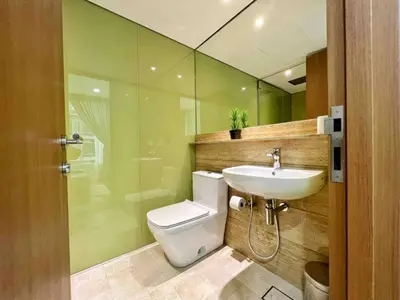 a bathroom with a toilet and a sink and a shower at Premium Living Sky Suites - Twin Towers KLCC 2-min walk in Kuala Lumpur