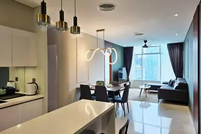 a kitchen and living room with a table and chairs at Premium Living Sky Suites - Twin Towers KLCC 2-min walk in Kuala Lumpur