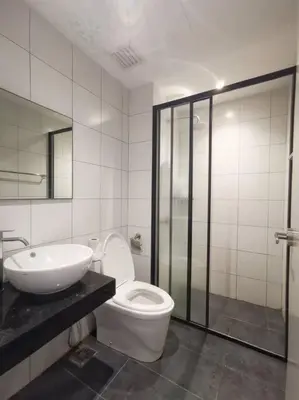 a bathroom with a toilet and a sink and a shower at Chamber Suite Klcc & KL Tower view in Kuala Lumpur