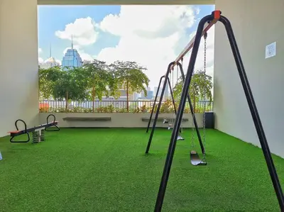 an empty room with a playground with green grass at Chamber Suite Klcc & KL Tower view in Kuala Lumpur