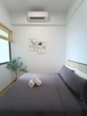 a bedroom with a bed with a towel on it at COL 31B Modern Infinity Pool KLCC View in Kuala Lumpur