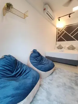 a room with two beds with blue blankets and a sink at COL 108A Modern KLCC Balcony View & Infinity Pool in Kuala Lumpur