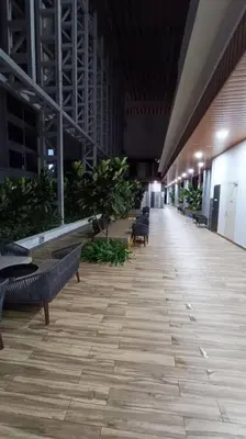 a hallway with benches and plants in a building at COL 108A Modern KLCC Balcony View & Infinity Pool in Kuala Lumpur
