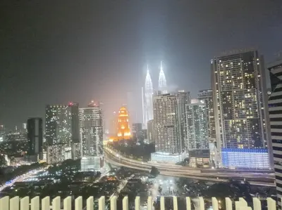 a night view of a city with tall buildings at COL 108A Modern KLCC Balcony View & Infinity Pool in Kuala Lumpur