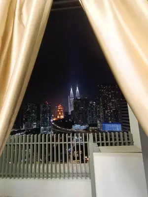 a view of a city skyline at night at COL 108A Modern KLCC Balcony View & Infinity Pool in Kuala Lumpur