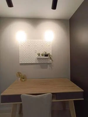 a dining room table with two lights on the wall at COL 108A Modern KLCC Balcony View & Infinity Pool in Kuala Lumpur