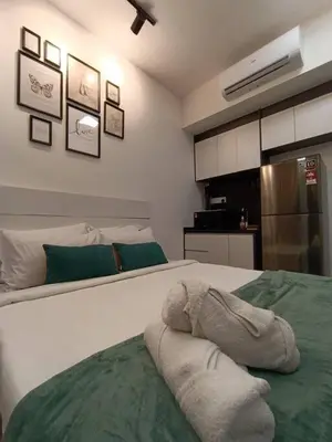 a bedroom with a bed with towels on it at COL 108B Modern KLCC Balcony View & Infinity Pool in Kuala Lumpur