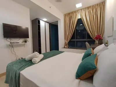 a bedroom with two white beds and a flat screen tv at COL 108B Modern KLCC Balcony View & Infinity Pool in Kuala Lumpur