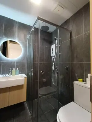 a bathroom with a shower and a toilet and a sink at COL 108B Modern KLCC Balcony View & Infinity Pool in Kuala Lumpur