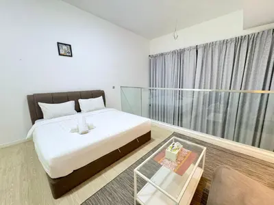 a bedroom with a bed and a glass table at Mcity Ampang Duplex Groove in Kuala Lumpur