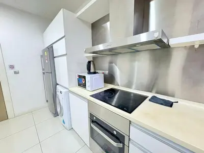 a kitchen with a sink and a refrigerator at Mcity Ampang Duplex Groove in Kuala Lumpur
