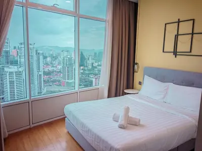 a hotel room with a bed and a large window at vortex Suites KLCC in Kuala Lumpur