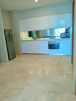 an empty kitchen with blue cabinets and appliances at vortex Suites KLCC in Kuala Lumpur