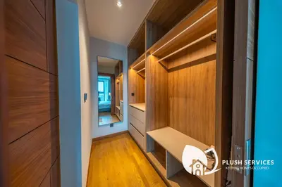 a hallway with wood paneling and a dressing room at Alfa Bangsar by Plush in Kuala Lumpur